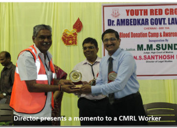 Director presents a momento to a CMRL Worker